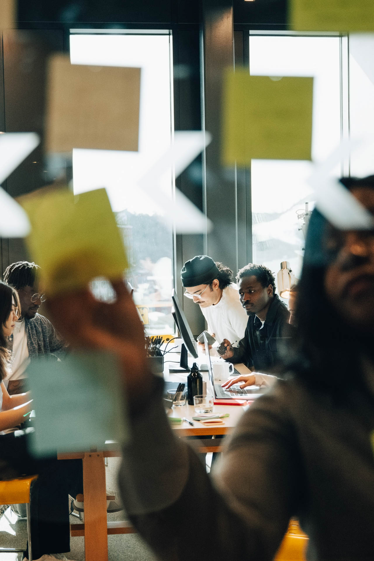 Businesswoman Having Brainstorm Session With Coworkers Sitting In Background